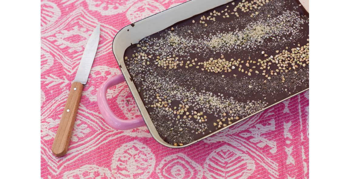 Rainbow chocolate bars of puffed rice, topped with hemp, chia and buckwheat